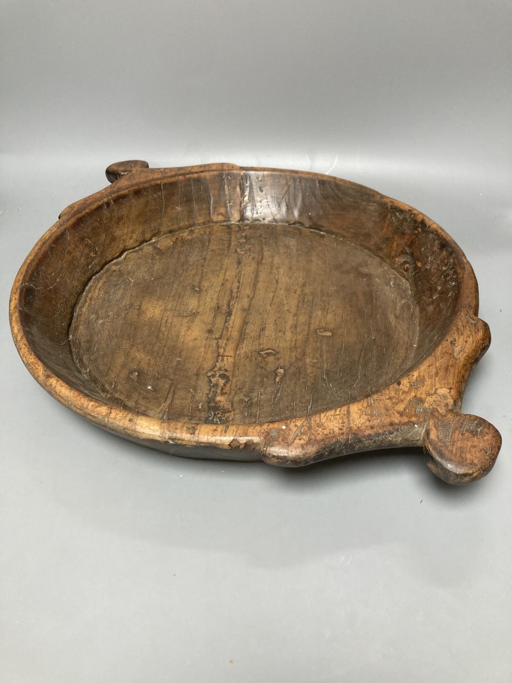 A carved elm two handled serving dish, carved from the solid, 42cm